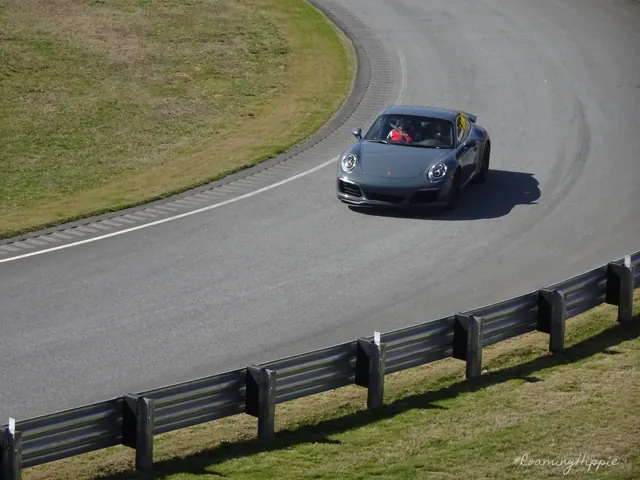 A Porsche rounding a curve on a race track