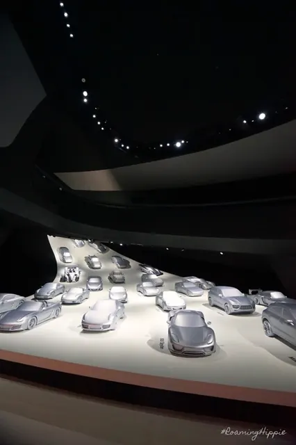 A museum display of silver cars seen from above